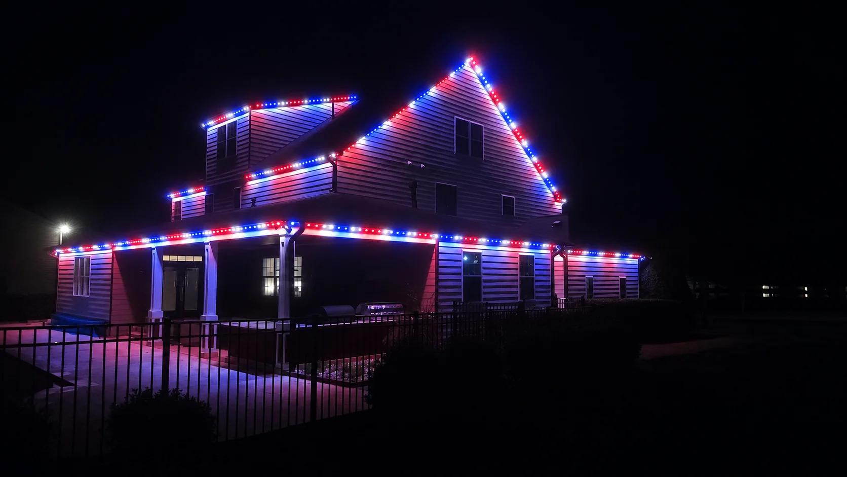 Red, white, and blue permanent roofline lights for July 4th on a Raleigh home