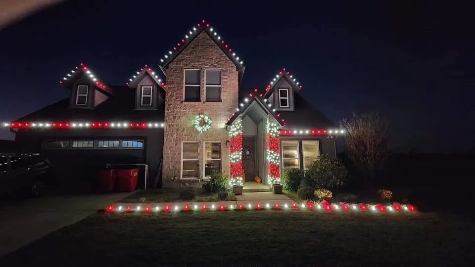 Custom accent lighting on columns and greenery.